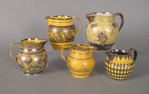 Five canary and silver resist pitchers, early 19