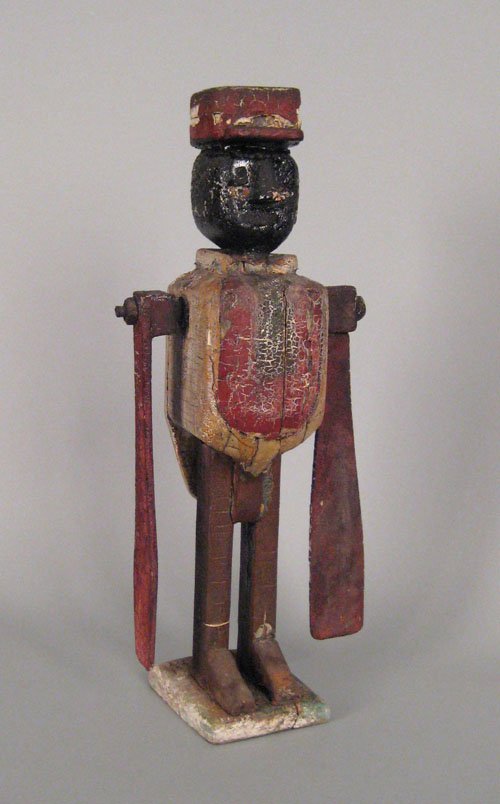 American carved pine whirligig, ca. 1915, the b: American carved pine whirligig, ca. 1915, the body is a black train conductor with cap and uniform. Exhibited Hospital of the University of Pennsylvania Antique Show 1976. Provenance: Henry Coger.