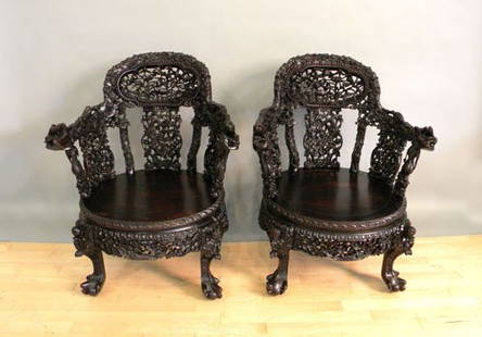 Pair of carved Chinese armchairs.: Pair of carved Chinese armchairs.