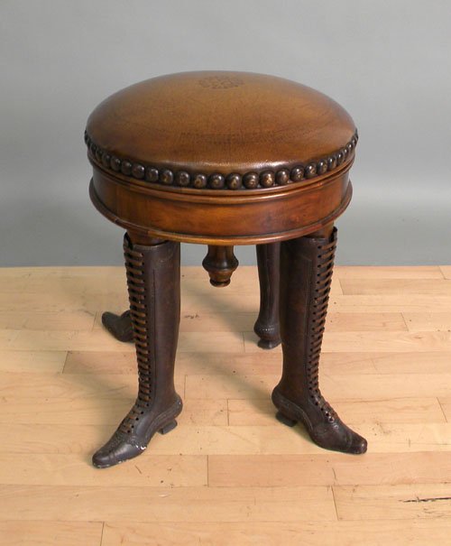 Leather top revolving stool with iron boot form l: Leather top revolving stool with iron boot form legs, 20'' h., 15'' l.