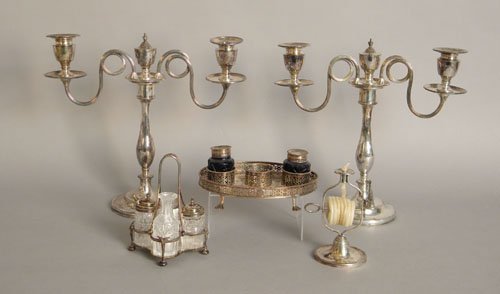 Group of silver plated tableware to include a wax: Group of silver plated tableware to include a wax jack, condiment set, standish and a pair of candelabra.