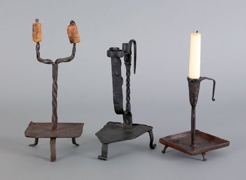 Three wrought iron table top lighting devices, 1: Three wrought iron table top lighting devices, 18th c., 10'' h., 8 1/2'' h., and 6'' h.