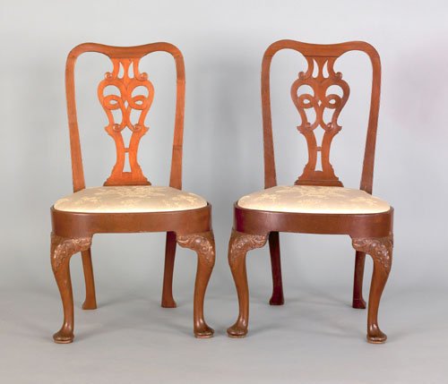 Pair of George II mahogany dining chairs, mid 18: Pair of George II mahogany dining chairs, mid 18th c., with a pierced splat and compass seats supported by cabochon carved legs terminating in pad feet.