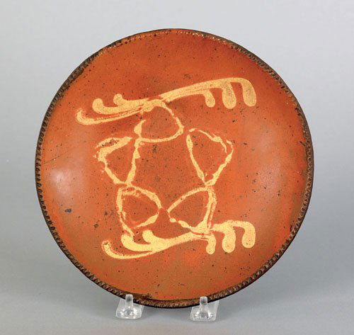 American redware plate, 19th c., with yellow sl: American redware plate, 19th c., with yellow slip star decoration, 8 1/4'' dia.