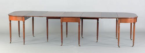 Pennsylvania Sheraton mahogany three part dining: Pennsylvania Sheraton mahogany three part dining table, ca. 1825, with rounded corner ends and drop leaf center section, supported by reeded legs, together with two leaves, 16 1/4'', open - 29 1/2'' h