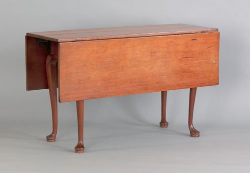 New England Queen Anne cherry drop leaf dining t: New England Queen Anne cherry drop leaf dining table, ca. 1760, with a scalloped apron and cabriole legs terminating in pad feet, 28 1/4'' h., 17 1/2'' w., 48 1/4'' d.