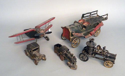 Tin hill climber auto, 13'' l., together with a wo: Tin hill climber auto, 13'' l., together with a wooden airplane, iron fire pumper, towing car, and train.