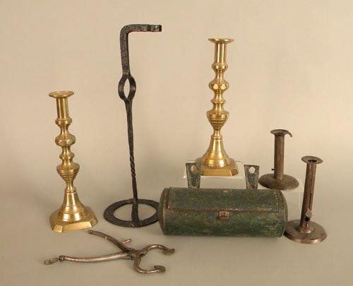 Metalware to include a pair of brass candlesticks: Metalware to include a pair of brass candlesticks, iron rush light, two hogscraper candlesticks, sugar nippers, and a candlebox.