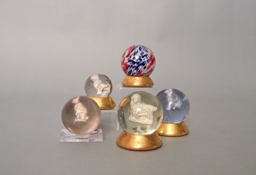 Four sulfide marbles, together with a swirl glass: Four sulfide marbles, together with a swirl glass marble, 2'' dia.