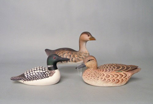Three duck decoys to include grebe signed John H: Three duck decoys to include grebe signed John Holloway 1974, 9'' l., loon signed Crammer 1985 and a green wing teal initialed H.M. (Herb Miller), 9 1/2'' l.