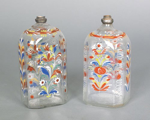 Two Stiegel type glass enamel decorated bottles,: Two Stiegel type glass enamel decorated bottles, ca. 1800, both with floral decoration and pewter collars, 6 3/4'' h.