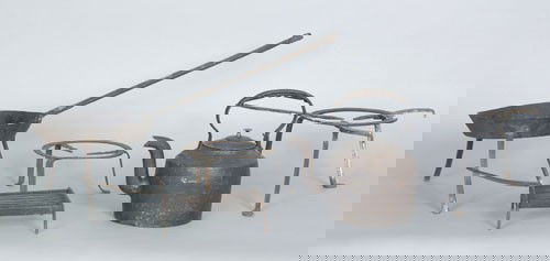 Wrought iron hearth equipment, late 18th c., to: Wrought iron hearth equipment, late 18th c., to include three trivets, footed skillet, and a cast iron kettle.