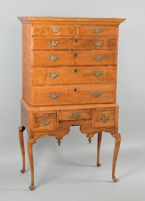 New England Queen Anne maple high chest, the up: New England Queen Anne maple high chest, the upper section with a molded cornice over two short and four long drawers, resting on a base with three drawers supported by cabriole legs terminating in pa