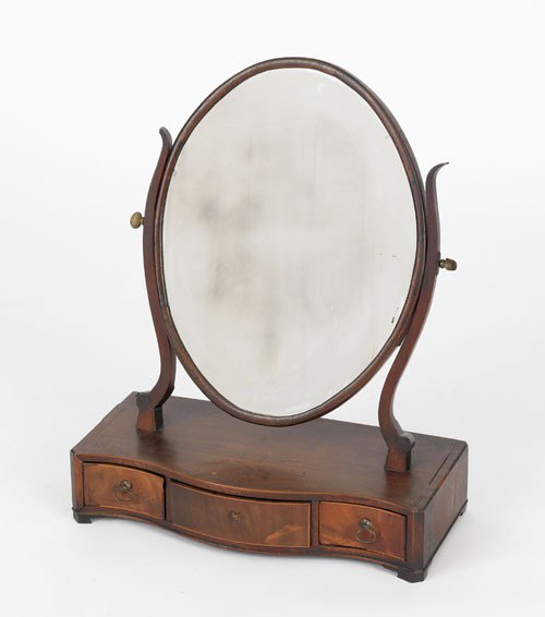English Hepplewhite mahogany shaving mirror, ca.: English Hepplewhite mahogany shaving mirror, ca. 1790, with an oval mirror above a serpentine front base with three small drawers. Sold by order of the trustees of the Philadelphia Museum of Art to be