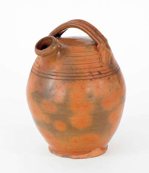 New England redware harvest jug, 19th c., with: New England redware harvest jug, 19th c., with mottled orange and green glaze, 11'' h.