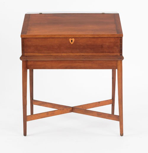 Southern Federal cherry desk on frame, ca. 1810: Southern Federal cherry desk on frame, ca. 1810, the fall front enclosing a three drawer interior, above a heart inlaid escutcheon resting on a frame with square tapering legs joined by a cross stretc