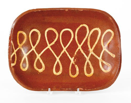 English redware loaf dish, 19th c., with yellow: English redware loaf dish, 19th c., with yellow slip loop decoration, 12 1/4'' h., 16 1/2'' w.