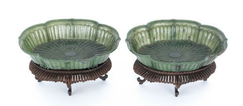Pair of Chinese spinach green jade Mughal style: Pair of Chinese spinach green jade Mughal style bowls, 18th/19th c., of oval form with translucent overlapping flower petals radiating outward, terminating in a scalloped flaring rim, supported by fou