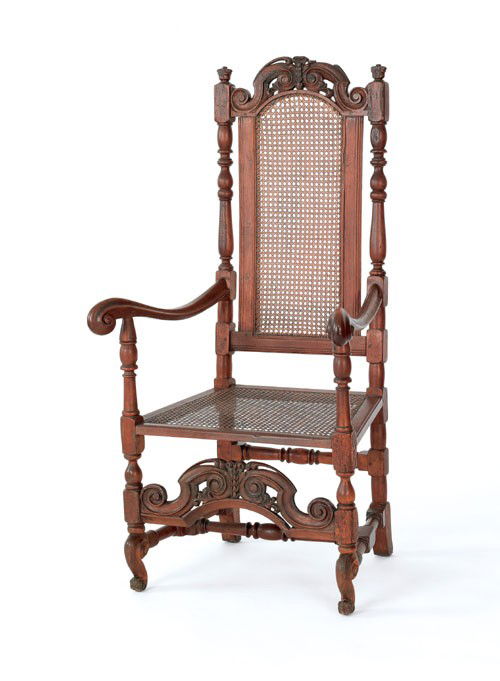 English walnut armchair, ca. 1695, with a carve: English walnut armchair, ca. 1695, with a carved crest rail and medial stretcher, cane seat and back, supported by Flemish feet. Sold by order of the trustees of the Philadelphia Museum of Art to bene