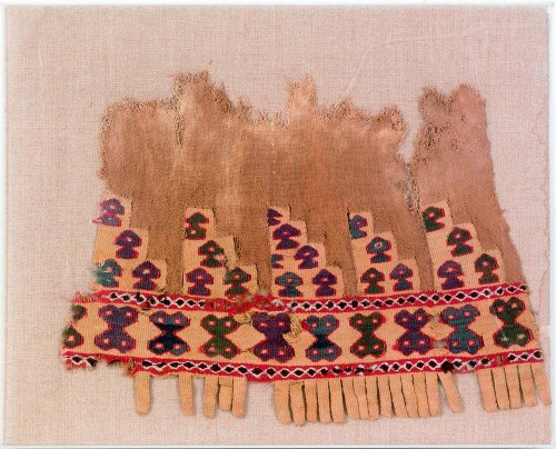 Five framed textile fragments together with a bon: Five framed textile fragments together with a bone rest.