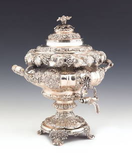 Irish silver hot water urn, 1830-1831, bearing th: Irish silver hot water urn, 1830-1831, bearing the touch of Smith & Gamble, Dublin with profuse repousse floral decoration, the reverse with coat of arms, inscribed Fortitudine Et Prudentia, 17 1/2''