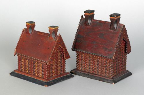 Two chip carved painted house banks, 19th c., b: Two chip carved painted house banks, 19th c., both from the same hand with salmon, green and yellow surfaces, 7 1/2'' h., 6'' w., 4'' d. and 6'' h., 6'' w., 4 1/2'' d.