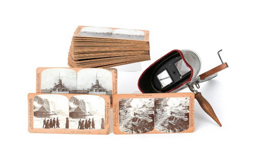 Hand-held stereoscope, together with a group of c: Hand-held stereoscope, together with a group of cards.