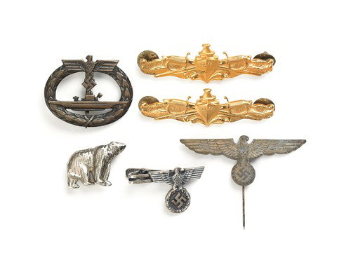 One Kriegsmarine submarine pin, together with two: One Kriegsmarine submarine pin, together with two naval tunic pins (gold), one polar bear pin, one eagle and swastika stick, and one tie clasp.