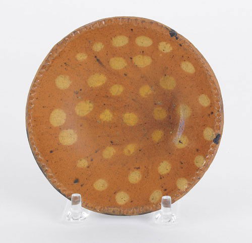 Miniature redware plate, 19th c., with yellow s: Miniature redware plate, 19th c., with yellow slip dotted decoration, 4 3/8'' dia. Provenance: Christies, Collection of Paul Flack, September 6, 1997.