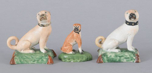 Pair of Staffordshire pearlware pugs, early 19th: Pair of Staffordshire pearlware pugs, early 19th c., 3 1/2'' h., together with a smaller figure, 2 1/2'' h.