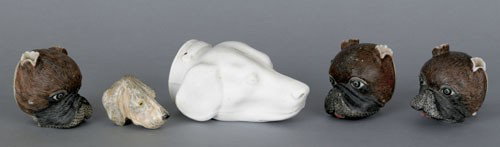 White ironstone hound-head stirrup cup, togethe: White ironstone hound-head stirrup cup, together with a set of three pug-head porcelain ornaments and a hound-head ornament.