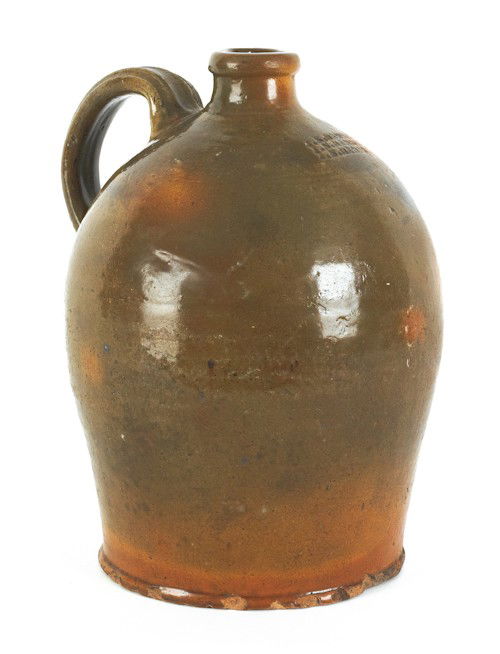 J.S. Henne (Berks County, Pennsylvania, active 1: J.S. Henne (Berks County, Pennsylvania, active 1840-1876), redware jug with mottled green and orange glaze, maker's stamp J.S. Henne beneath spout, 10 1/2'' h.