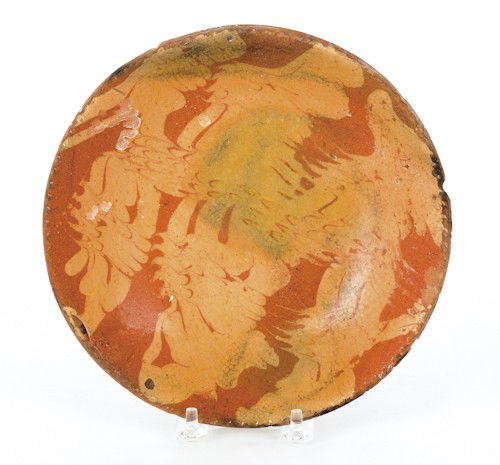 Pennsylvania redware pie plate, 19th c., with c: Pennsylvania redware pie plate, 19th c., with combed yellow slip decoration, 7 3/4'' dia.