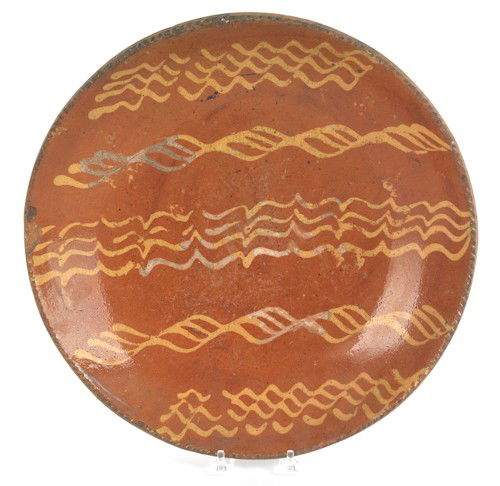 Pennsylvania redware charger, 19th c., with yel: Pennsylvania redware charger, 19th c., with yellow slip decoration, 14 1/2'' dia.