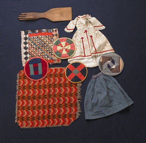 Four Amish potholders, together with a doll quilt: Four Amish potholders, together with a doll quilt, dated, 1892, flame stitch square, a doll dress and skirt, and a glove stretcher.