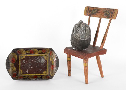Cast iron boot scraper decorated with an African: Cast iron boot scraper decorated with an African American figure, together with a tole bread tray, copper food mold, and miniature painted chair.