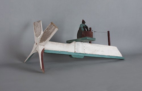 Folk art painted wooden whirligig of a mammy wash: Folk art painted wooden whirligig of a mammy washing clothes.