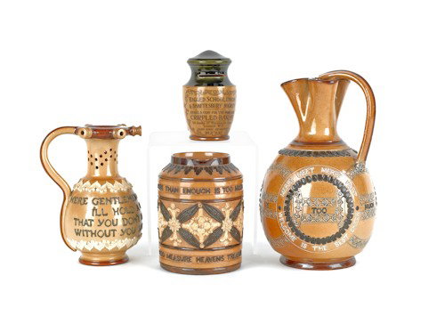 Doulton Lambeth motto pitcher, initialed AW, to: Doulton Lambeth motto pitcher, initialed AW, together with a puzzle jug by Ethel Beard, a bank, and a mug, tallest - 9 3/4'' h.