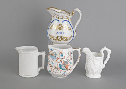 Two painted porcelain pitchers, together with two: Two painted porcelain pitchers, together with two white ironstone pitchers.