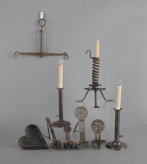 Miscellaneous tin and iron, 19th/20th c., to incl: Miscellaneous tin and iron, 19th/20th c., to include two hogscraper candlesticks, one signed Shaw, and one signed BIL, fat lamps, a heart pan, a spiral candlestick, etc.