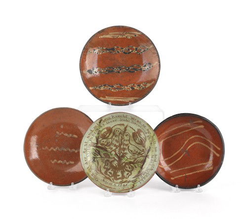 Three slip decorated redware plates, 19th c., tog: Three slip decorated redware plates, 19th c., together with an Isaac Stahl plate dated 1947, largest - 9'' dia.