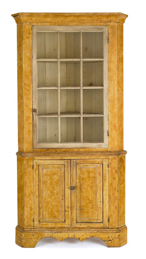 Pennsylvania painted two-part corner cupboard, e: Pennsylvania painted two-part corner cupboard, early 19th c., the ogee cornice over a glazed door resting on a base with raised panel doors, above a scalloped apron supported by bracket feet, 87 1/4''
