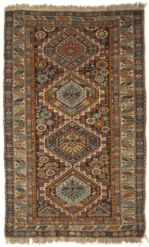 Caucasian throw rug with four medallions and mu: Caucasian throw rug with four medallions and multiple borders with geometrics, 5'4'' x 3'2''.