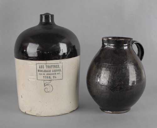 Large Pennsylvania redware pitcher, together with: Large Pennsylvania redware pitcher, together with a York, Pennsylvania stoneware jug, 13'' h., 16 1/4'' w.