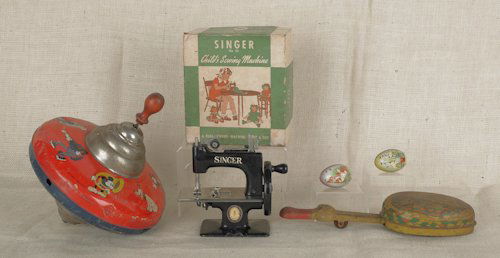 Child's Singer sewing machine, model #20, early: Child's Singer sewing machine, model #20, early 20th c., in original box, together with a Disney tin litho top, tin litho duck, and two tin eggs.