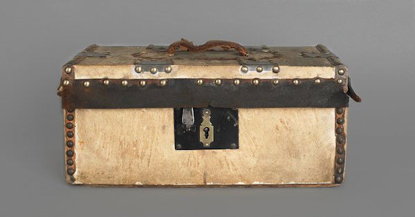 Hide covered lock box, 19th c., bearing the label: Hide covered lock box, 19th c., bearing the label of Shelton & Cheever, Boston, 6'' h., 14'' w., together with a painted hearth broom, 25'' l.
