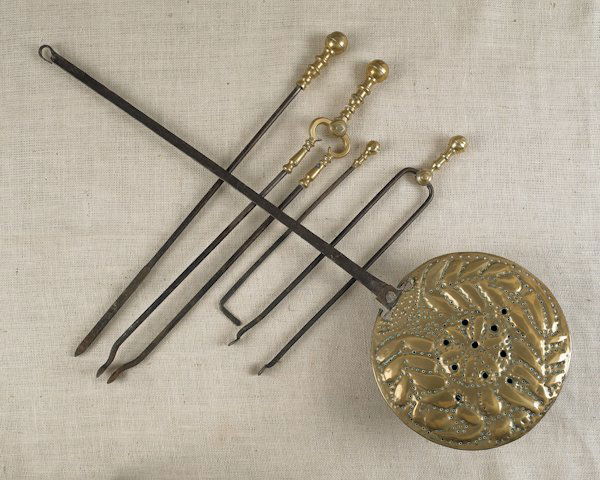 Group of brass fireplace accessories, 19th c., to: Group of brass fireplace accessories, 19th c., to include andirons, fire tools, a fender and a bed warmer.
