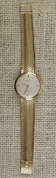 Patek Philippe man's gold wrist watch, the 18K ye: Patek Philippe man's gold wrist watch, the 18K yellow gold case with unclear hallmark and tapered mesh Patek Philippe band, marked 18K yellow gold, inscribed initials on reverse, the face approx. 33mm