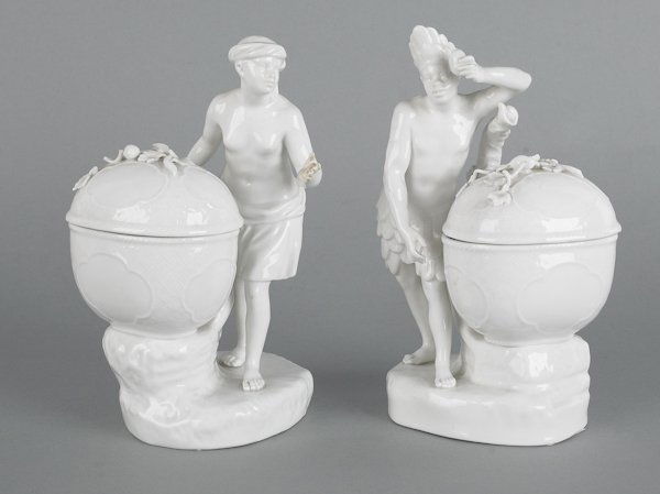 Pair of KPM blanc de chine Blackamoor figures, 1: Pair of KPM blanc de chine Blackamoor figures, 19th c., with covered cups, 7 1/4'' h. and 7 1/2'' h.