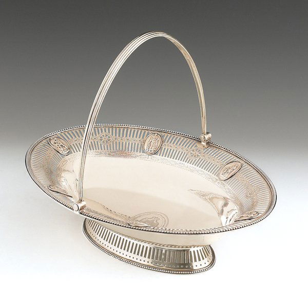 George III silver cake basket, 1781-82, bearing: George III silver cake basket, 1781-82, bearing the touch of Burrage Davenport, with a central engraved armorial and reticulated rim with applied cast mythological scenes, 4'' h., 14 1/2'' w., 29.7 oz